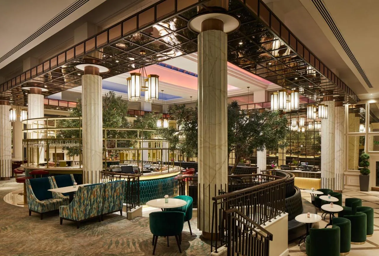 a lobby of a restaurant with tables and chairs at The Midland in Manchester